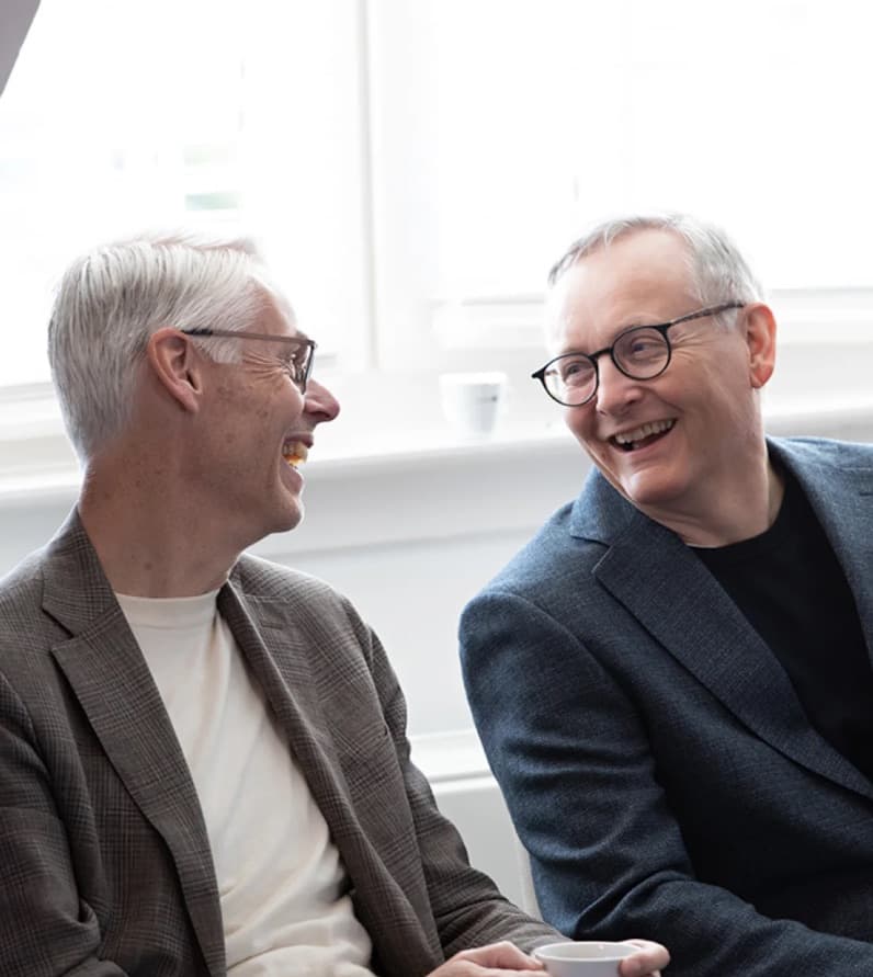 Two colleagues laughing together